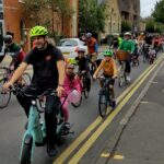 Photo of a mass of adults and children cycling along the road in Guildford